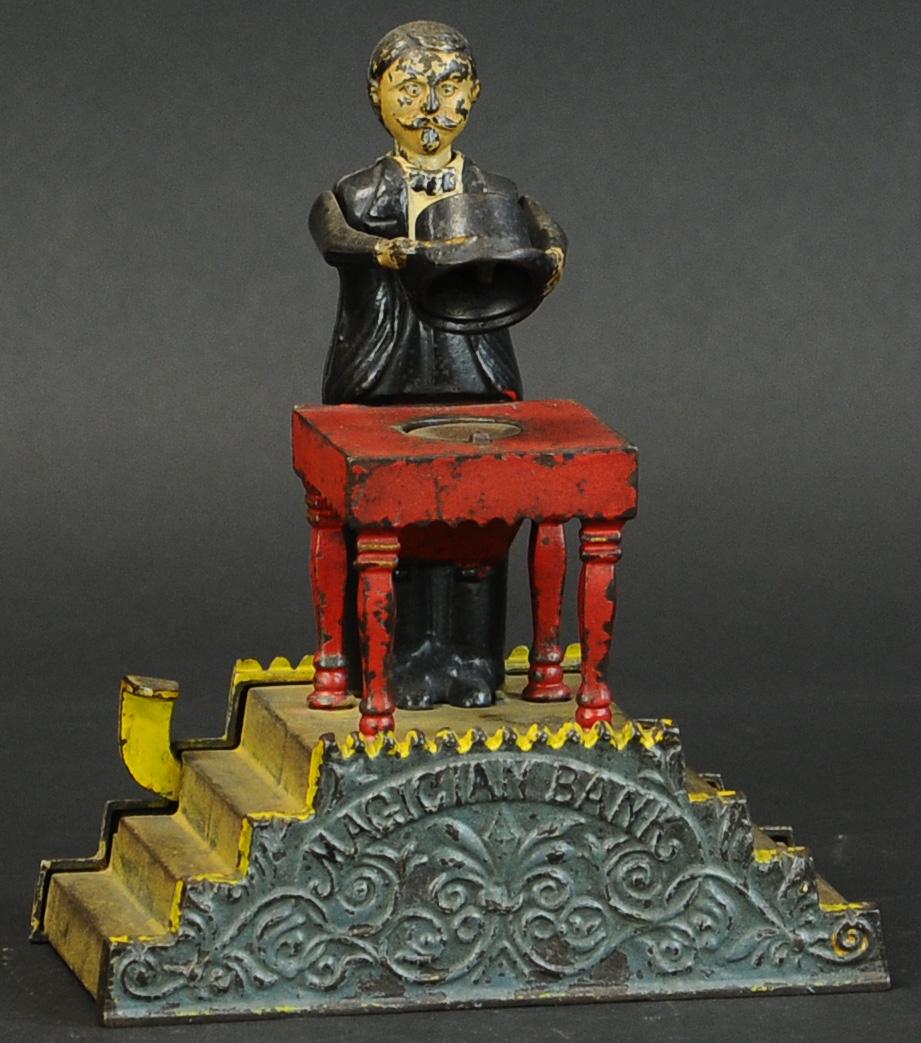 MAGICIAN MECHANICAL BANK: 529. MAGICIAN MECHANICAL BANK | J&E Stevens Co. | 9.5" h. | (VG Cond.) | $2,500 - $4,500