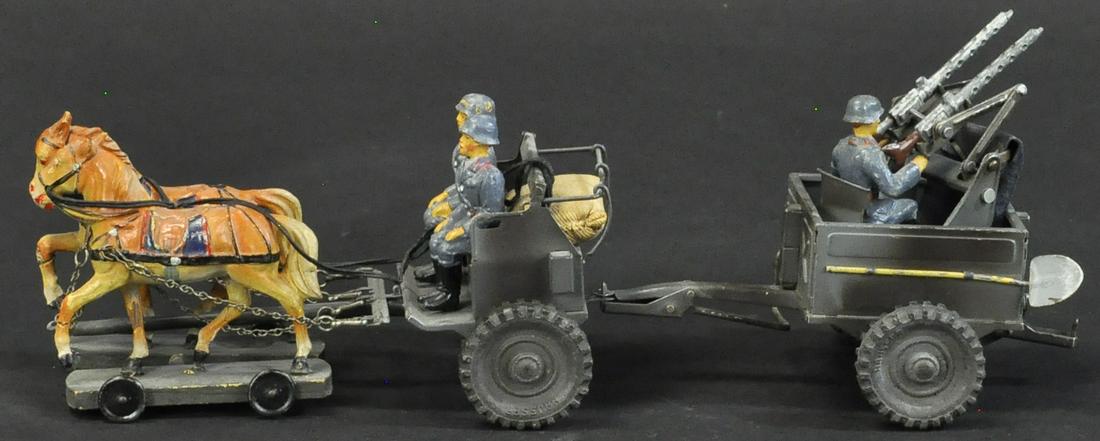 HAUSSER RARE AA HORSE CART: 1369. HAUSSER RARE AA HORSE CART | Rare horse drawn cart with AA machine gun set, comes with Luftwaffe figures. | 12" l. | (Exc. Cond.) | $400 - $600