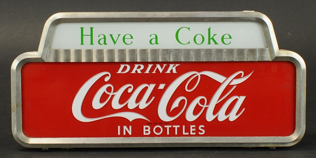 HAVE A COKE LIGHT-UP SIGN: 1468. HAVE A COKE LIGHT-UP SIGN | Drink Coca-Cola in Bottles, light-up sign. Provenance: Ray Burgess Collection. | 19.5" h. x 9.5" w. | Super clean and working well, (VG - Exc. Cond.) | $350 - $700