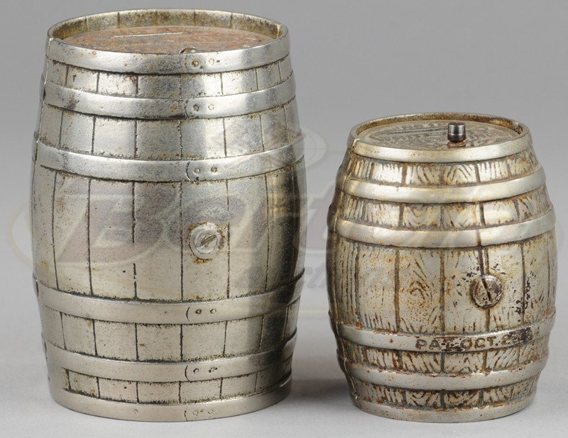 TWO WHITE CITY PUZZLE SAVINGS STILL BANKS: Nicol, c. 1890's, nickeled cast iron, good detail to barrel slats, embossed lids with coin slots, includes large and small version. 3 7/8" to 5 1/8" h.