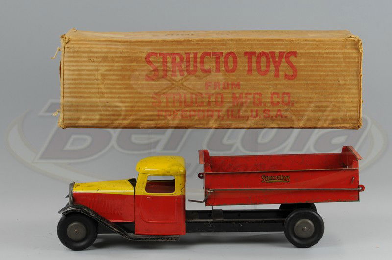 BOXED STRUCTO DUMP TRUCK: C. 1928, pressed steel, painted in yellow and red cab with red body, black chassis, hard black rubber tires. 22" l.