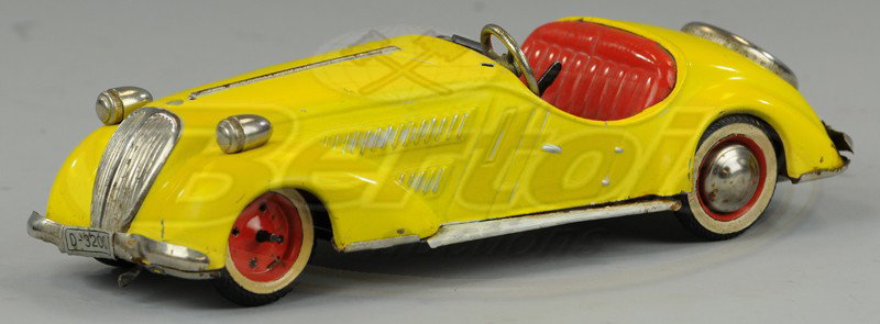 DISTLER SPORTS CAR: Tinplate body, U.S. Zone Germany, done in yellow, red seating, clockwork driven. 9 1/2" l.