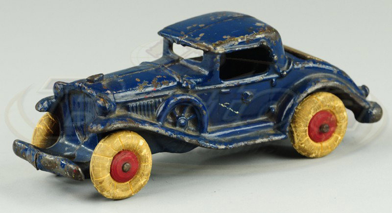 A.C. WILLIAMS COUPE WITH RUMBLE SEAT: C. 1930's, cast iron, blue coupe features nickel opening rumble seat, rubber tires, cast spare on side. 6 1/4" l.