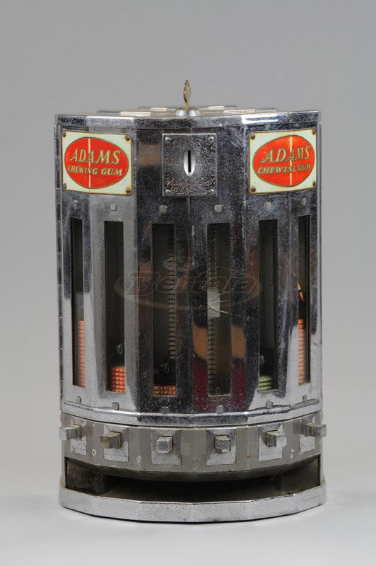 ADAMS CHEWING GUM DISPENSER: Stewart & McGuire DVC., NYC, one cent vending machine, chrome case has assorted gum packs visible at glass view holders, includes key. 15 3/4" h.
