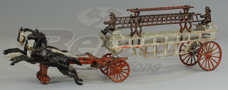 DENT HORSE DRAWN HOOK & LADDER WAGON: Cast iron, painted in white, red ladder supports, spoke wheels and three ladders, seated fireman at front and back seats, drawn by three horse team. 27" l.
