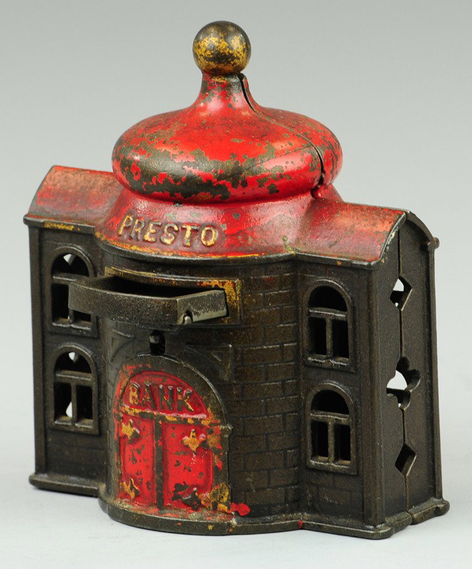 PRESTO BANK: Kyser & Rex, cast iron, japanned finish with red roof and door, tray opens when lever is depressed, embossing on front. 4 1/2" h.
