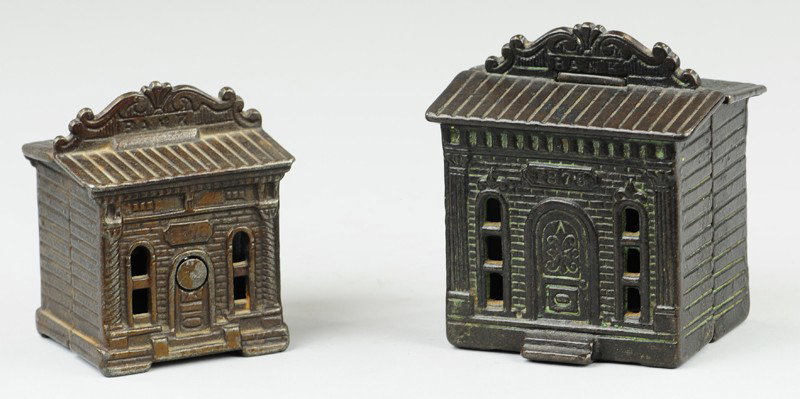 LOT OF TWO 1876 BANKS: Judd Mfg., c.1895, cast iron, includes both sizes of building banks with roof top marquees debossed "Bank." 2 7/8" to 3 3/8" h.