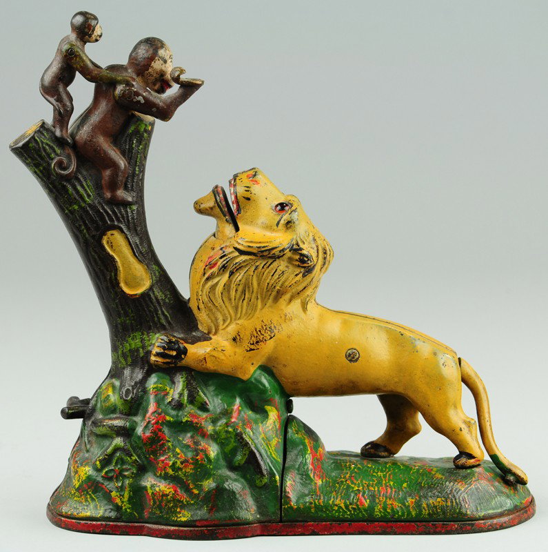 LION AND MONKEYS MECHANICAL BANK: Kyser & Rex Co., designed by Louis Kyser & Alfred C. Rex, patented 7/17/1883. "Single Peanut" variety, 8.5" tall. Place a coin in the monkey's hand, and touch a spring at the root of the tree. The mon