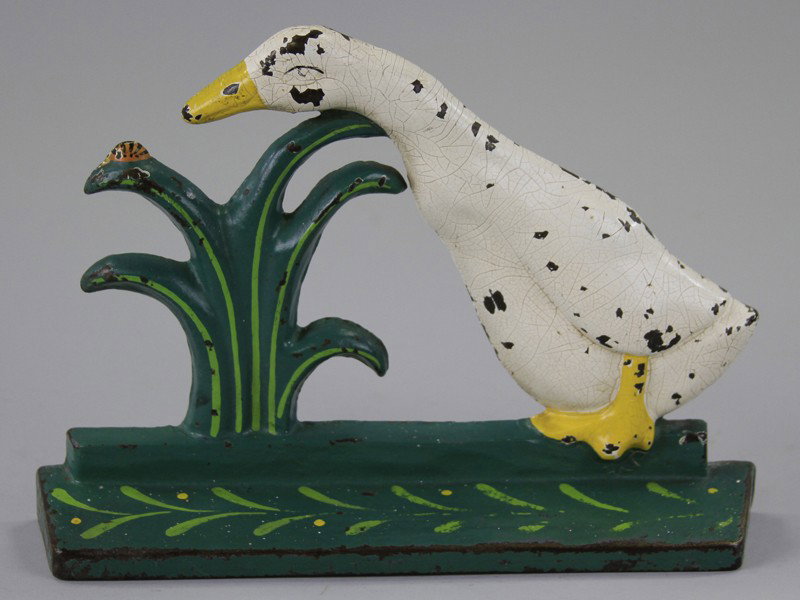 DUCK PECKING LADYBUG DOORSTOP: Cast iron, Littco Products, charming piece portrays duck extending neck to get closer look at bug atop plant leaf. 7 1/2" h. x 10 1/2" l.