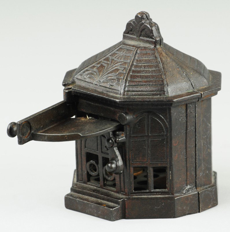 SNAPPIT MECHANICAL BANK: H.L. Judd Mfg. Co., cast iron, opening front door and placing coin on shelf allows deposit when released. 4" h.