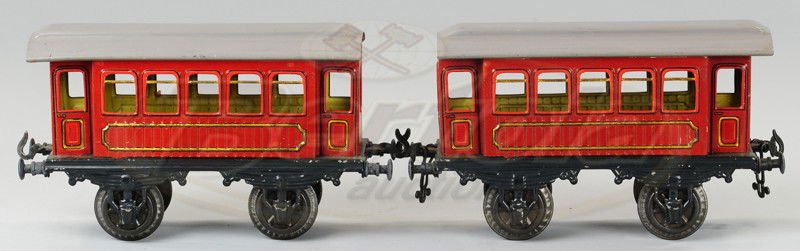 KARL BUB PASSENGER CARS: Lithographed tin, done in brown bodies, gray roofs, embossed simulated wood sides. Cars 6 1/2" l.