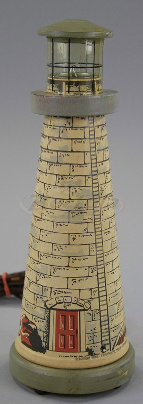 LIGHTHOUSE TABLE LAMP: Boxed example, Sealright Kone, made of lithographed paper, celluloid light tower, wood roof, electric powered. 12 3/4" h.