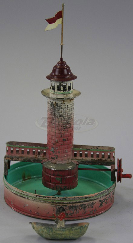 FALK LIGHTHOUSE WITH MOAT STEAM ACCESSORY: Germany, hand painted tin, done in pink and white, green interior repainted, fully railed catwalk to lighthouse on both sides, flag at top. 9" h.