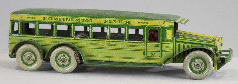 STRAUSS "CONTINENTAL FLYER" BUS: Lithographed tin, done in green body colors, yellow trim, lettered sides, seated driver, key wind operated. 11 1/2" l.