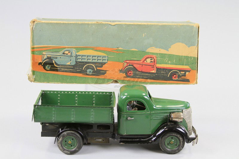 BOXED VEBE DUMP TRUCK: France, tinplate toy done in green body, clockwork driven, opening doors and lift gate, rubber tires, seated composition driver, electric light wires missing. 12 1/4" l.