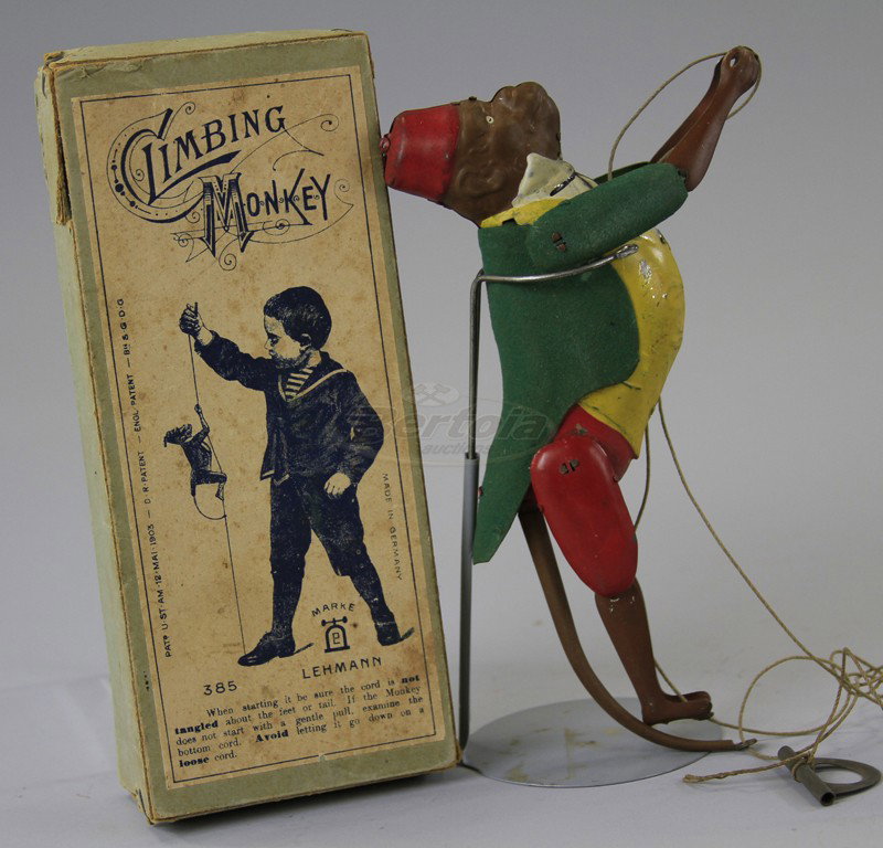 LEHMANN CLIMBING MONKEY: Boxed example, Germany, lithographed and hand painted tin with rough sprayed green jacket, popular pull string toy with inner mechanism allowing for simulated climbing action. 8" l.