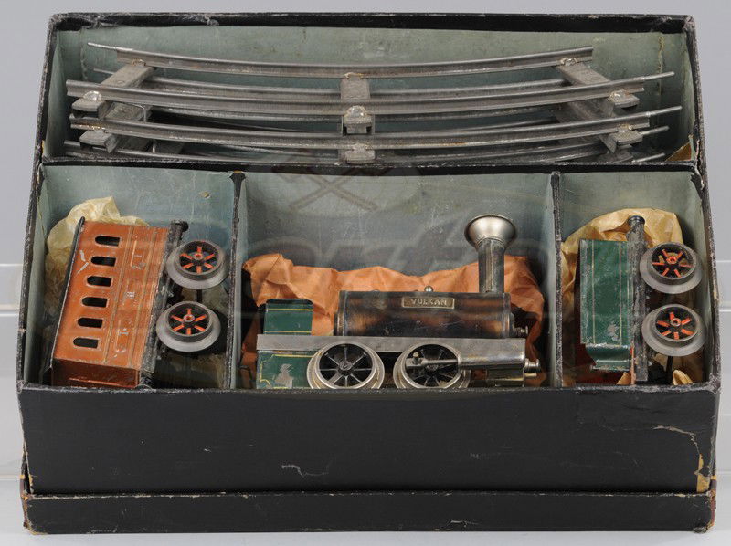 ERNST PLANK BOXED TRAIN SET: Germany, includes; Vulkan steam locomotive with tender, No.II Coach done in hand painted brown, original track, appears to be a gauge 2 example, very early piece. Car 5" l.
