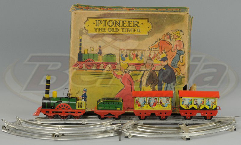 BOXED KARL BUB TRAIN SET: Lithographed tin, made in Western Germany, colorful set includes locomotive, tender and two coaches, complete with track, clockwork driven. 17 1/2" overall length.