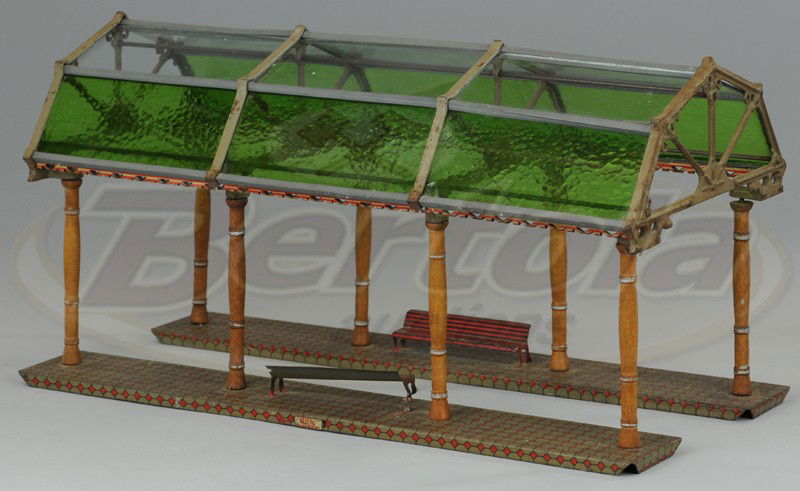 IVES GLASS COVERED PLATFORM STATION: Lithographed tin bases with tin benches, colored glass inserts, cast iron frames, wooden pole supports, nice litho base pattern. 18 1/2" l.