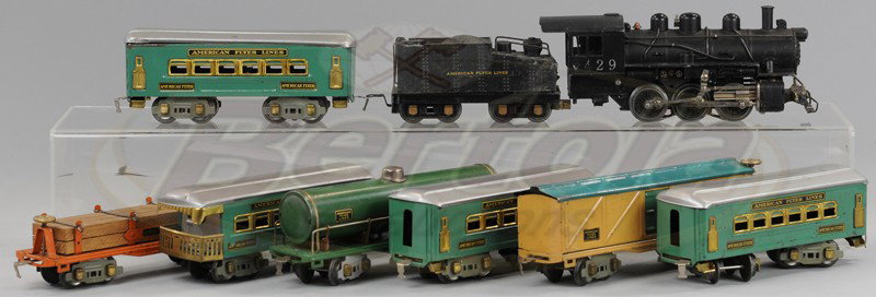 AMERICAN FLYER TRAIN LOT: Grouping includes the 429, 0-6-0 engine and tender together with a green four passenger car set and three freight cars. Cars 7 1/4" to 9 1/4".