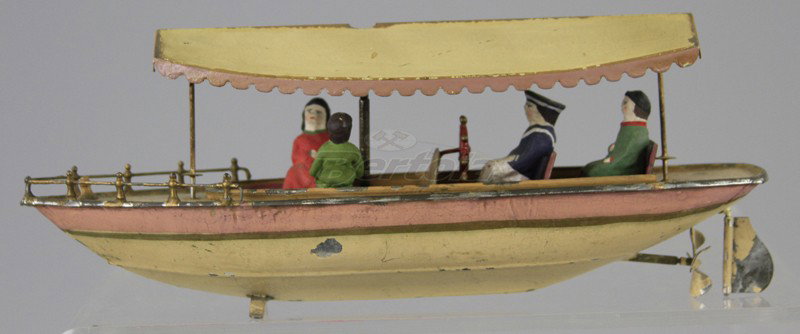 FLEISCHMANN RIVER BOAT: Railed bow, canopy covered passenger seating, painted in pink and white, nice accents, seated figure, clockwork driven. 10" l.