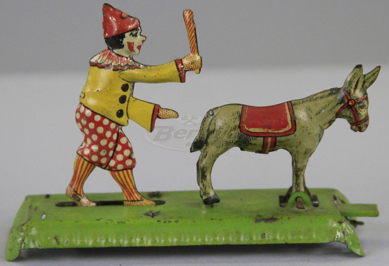 MEIER CLOWN HITTING DONKEY PENNY TOY: Germany, lithographed tin, lever allows articulated action, donkey appears to buck at clown holding club. 4" l.