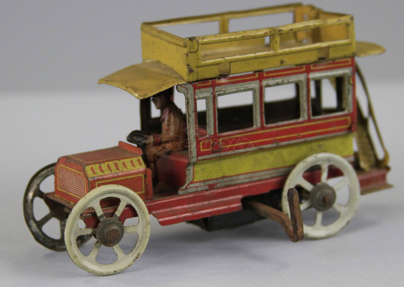 DISTLER BUS PENNY TOY: Germany, lithographed tin, done in red and yellow, stairs lead to railed upper deck, seated driver, key wind driven, bending to railing. 4 1/2" l.