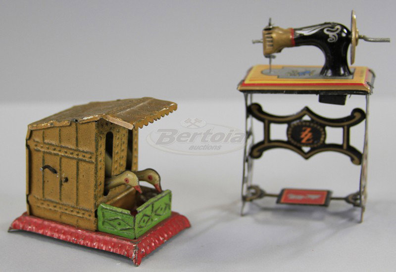 SEWING MACHINE AND GEESE PENNY TOYS: Both lithographed in tin, includes lever controlled feeding geese and lever activated sewing machine on table. 2 1/4" to 3" h.