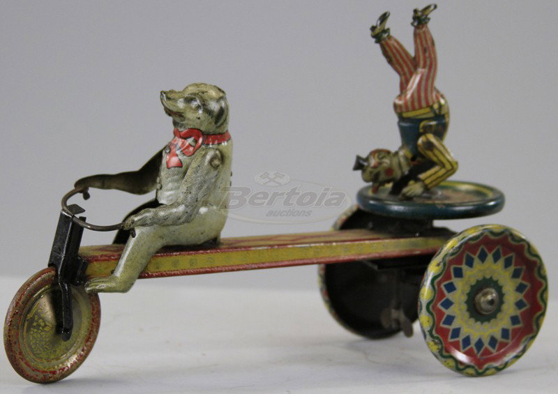 POLAR BEAR DRIVING CLOWN CART: Germany, lithographed tin, seated polar bear driver, performing clown on stand, colorful toy, disc wheels, key wind driven. 8" l.