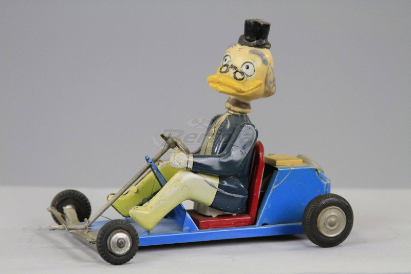 PROFESSOR VON DRAKE IN GO-KART: Marx, lithographed tin body with rubber head, depicted in open go-cart, friction powered. 6" l.