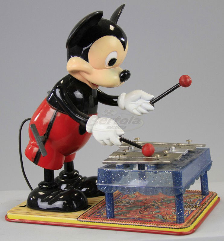 LARGE MICKEY MOUSE XYLOPHONE PLAYER: Marx, copy. W.D.P., key wind operated, hard plastic figure of Mickey able to strike cast keys with sticks, lithographed tin base, plastic xylophone frame, middle key is plastic. 11" h.
