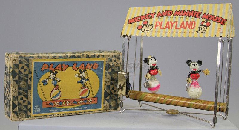 BOXED MICKEY AND MINNIE PLAYLAND: Japan, Geo. Borgfeldt Dist., copy. Walt Disney Ent., lithographed tin base and frame holds celluloid Mickey and Minnie standing on beach balls, key wind operated, cardboard canopy with graphics. 10 1/