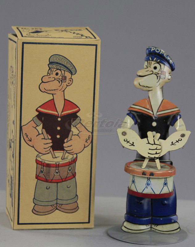 BOXED POPEYE THE DRUMMER: Chein, lithographed tin, classic hand held toy figure of Popeye with drum at waist, hand plunger controls drum stick tapping. 7 1/2" h.
