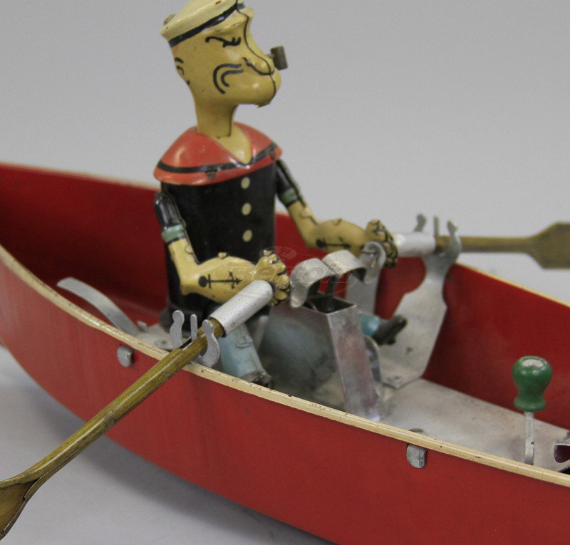 POPEYE IN ROWBOAT: Hoge Mfg., very desirable example, pressed steel rowboat painted in red, features Popeye at the oars on open bench, clockwork mechanism. 14" l.