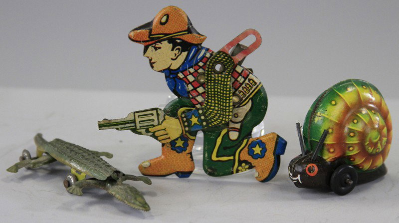 ASSORTED TIN TOY LOT: Includes Lehmann Gnome Snail, Cowboy clicker, and articulated Alligator penny toy, all done in lithographed tin. 2 1/2" to 4 1/2".