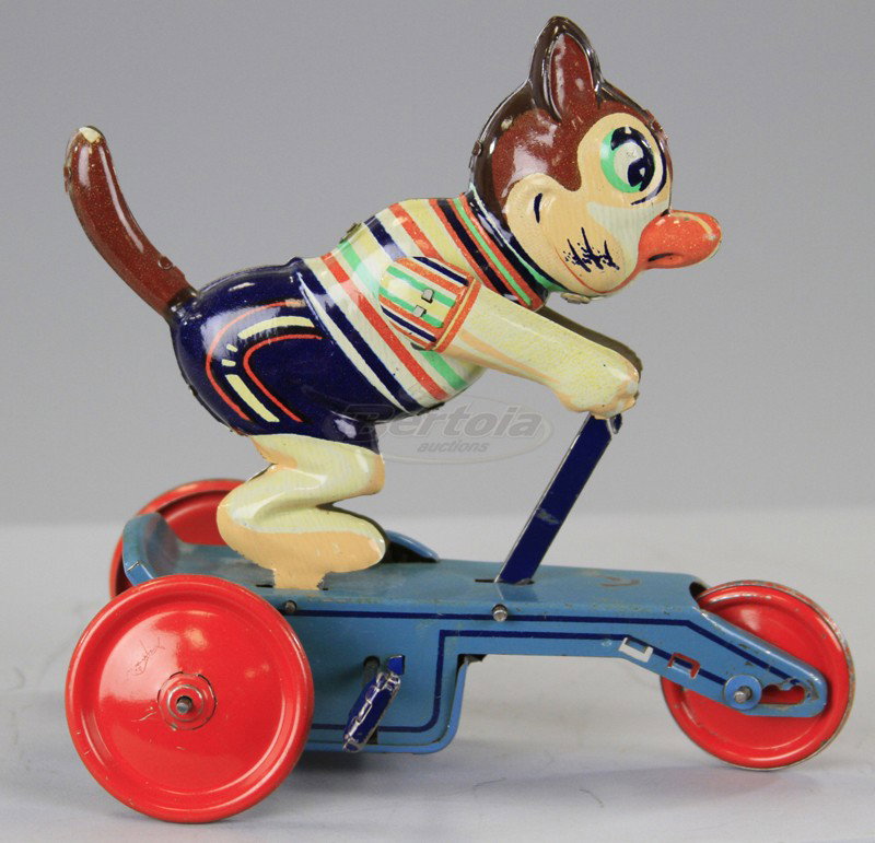 CAT RIDING SCOOTER: Lithographed tin, colorful toy depicts three wheel blue scooter, red disc wheels and suited cat, clockwork driven, made to resemble a Felix version. 6" l.