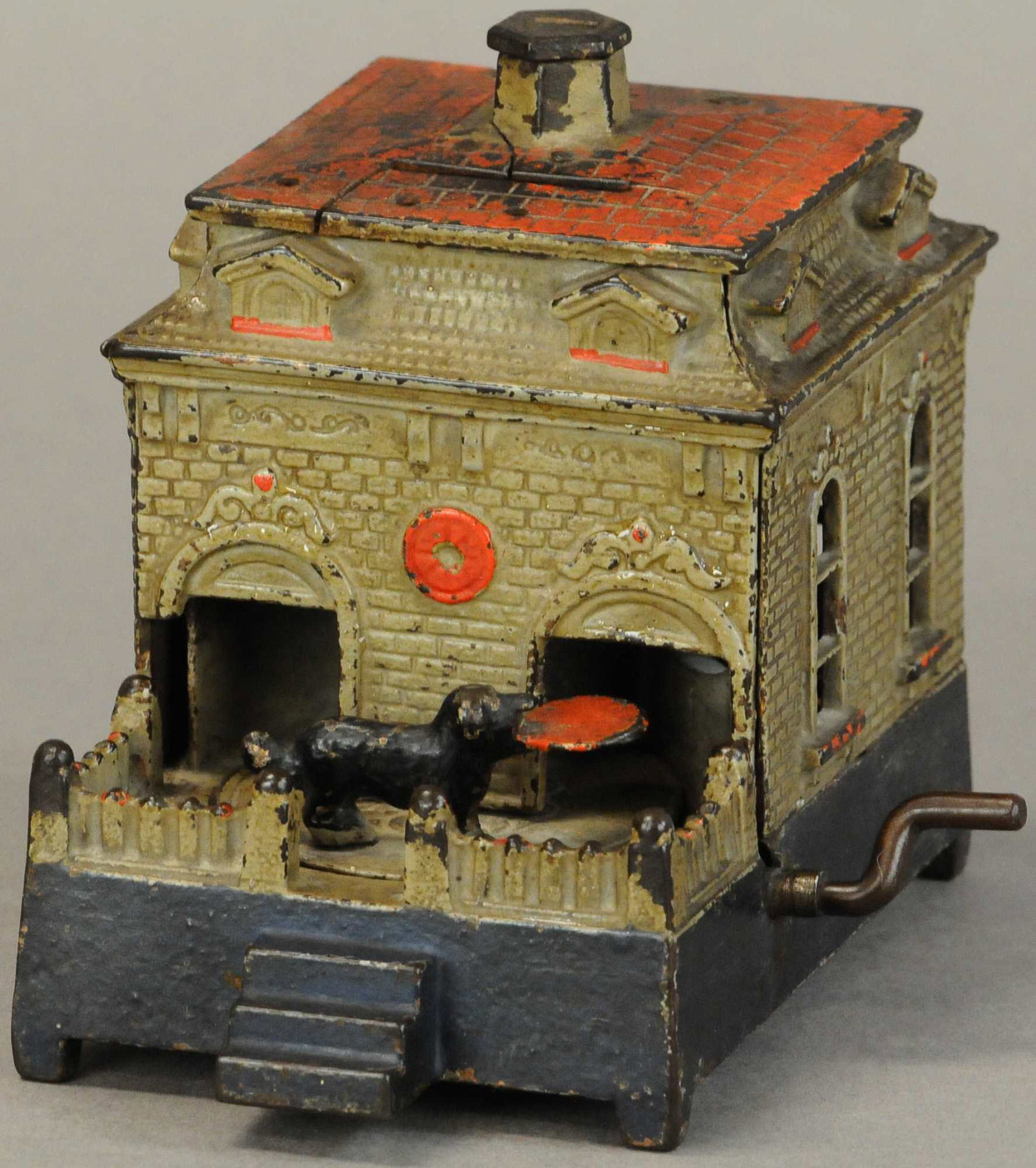 DOG ON TURNTABLE MECHANICAL BANK: 456. DOG ON TURNTABLE MECHANICAL BANK | Judd Mfg. | 5" h. | Replaced crank, crack at roof, paint is in All Original Condition. | $300 - $600