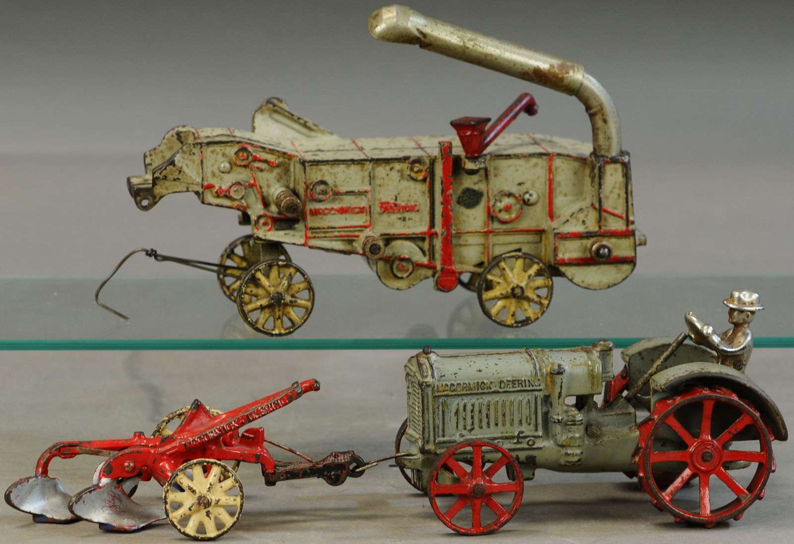 ARCADE MCCORMICK TRACTOR W/ THRASHER AND PLOW (1 of 4)