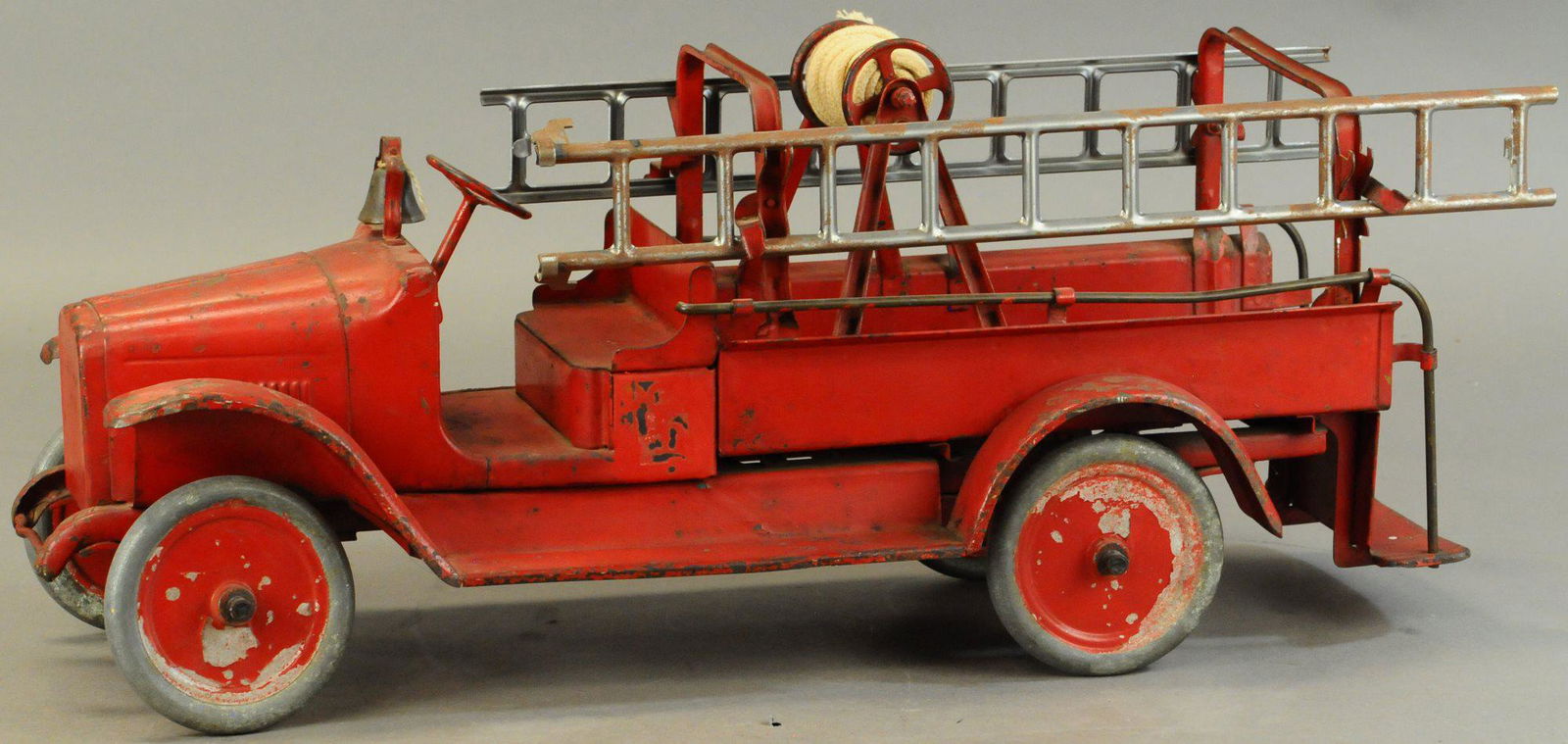 BUDDY L HOOK & LADDER TRUCK: 687. BUDDY L HOOK & LADDER TRUCK | 27.5" l. | Some overpaint in areas. | $300 - $600