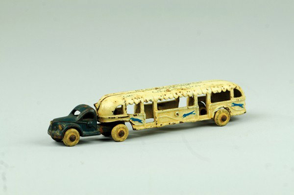 ARCADE CENTURY OF PROGRESS BUS: Cast iron, tandem model done in blue tractor and white trailer, rubber tires, roof stenciled "Century of Progress - 1933." 7 1/2" l.
