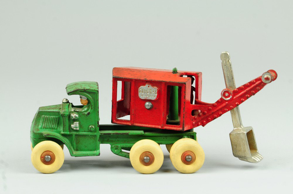 ARCADE GENERAL DIGGER: Cast iron, green enclosed cab, red housing with nickel shovel, embossed sides, rubber tires. 10" l.