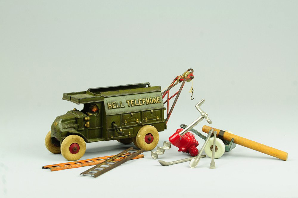 HUBLEY MACK TELEPHONE TRUCK: Cast iron, painted in familiar olive color, nickel water tank on side, includes drill, pole trailer, ladder and shovels. 9" l.