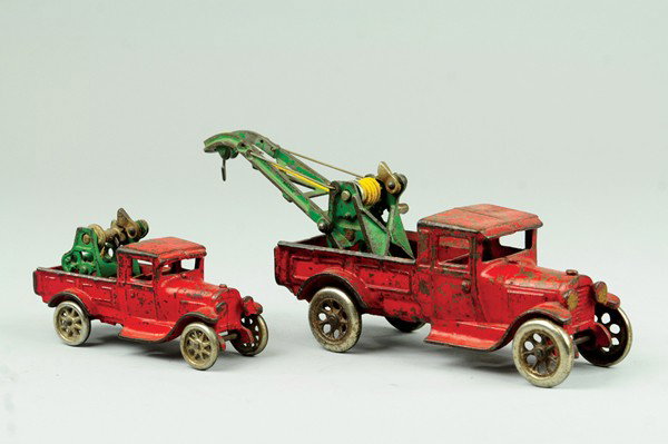 LOT OF TWO ARCADE FORD WRECKERS: Both cast iron and painted in red, nickel spoke wheels, larger truck has complete Weaver crane, each have door decal. 5 3/4" to 8 1/2" l.