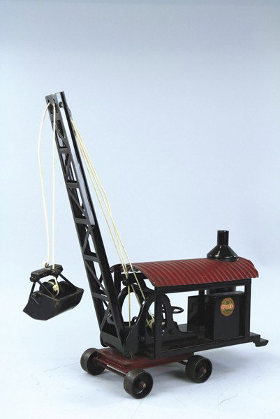 BUDDY 'L' CLAMSHELL DREDGE: C. 1920's, pressed steel, black housing with upright boiler, red roof, black boom with clamshell, roller wheels on red frame, early circular decal. 30" l.