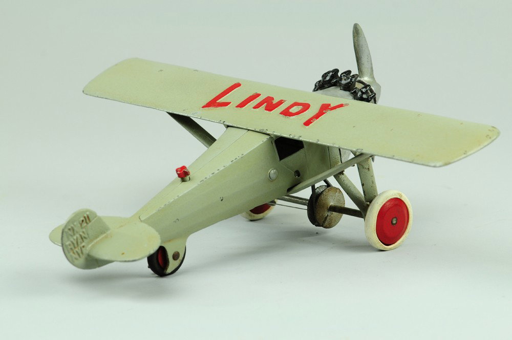 HUBLEY 'LINDY' AIRPLANE: C. late 1920's, cast iron, classic toy airplane painted in grey with 'Lindy' embossed in red on wing, black motor, nickel propeller and disc wheels. 13" wing.