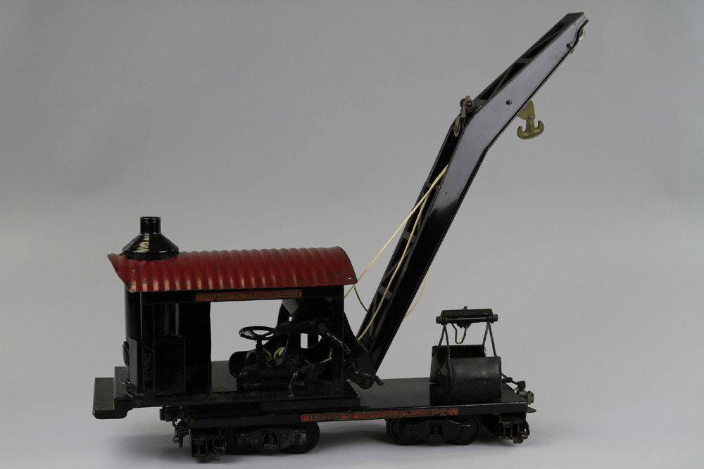 BUDDY 'L' LOCOMOTIVE WRECKING CRANE: C. 1930, outdoor railroad car, features open housing with vertical boiler and hand cranked boom with two hooks, housing able to swivel while car stationed on railroad tracks. 35" l.