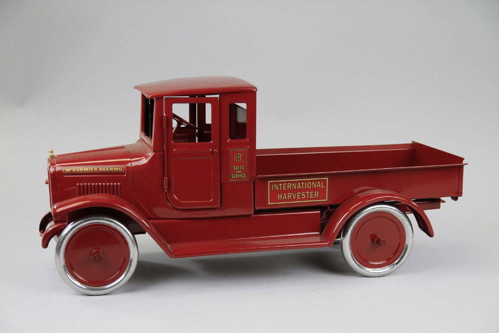 BUDDY 'L' IHC RED BABY EXPRESS TRUCK: T-Production, all enclosed cab with open cargo section and drop tailgate, spoke wheels, operating steering wheel. 24 1/4" l.