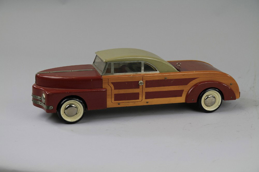 BUDDY 'L' TOWN AND COUNTRY CONVERTIBLE: Made of wood, painted brown and natural side panels, "woodie" model, grey roof, rear trunk opens, metal window frames, black wheels. 18 1/2" l.