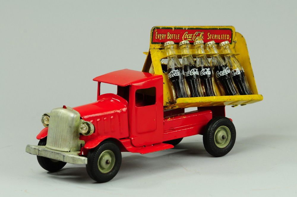 COCA-COLA TRUCK: Metalcraft, pressed steel, red cab with yellow dual side open body containing ten glass bottles and decal on marquee divider, disc wheels. 11" l.