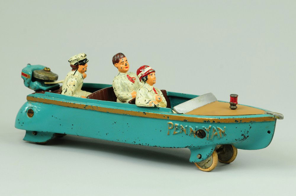 CONTEMPORARY "PENN YAN" SPEEDBOAT: Very impressive scale and mold details, this newer cast iron boat features seated passengers and motor tender with Johnson Seahorse outboard throttle, painted in blue overall with gold striping, this